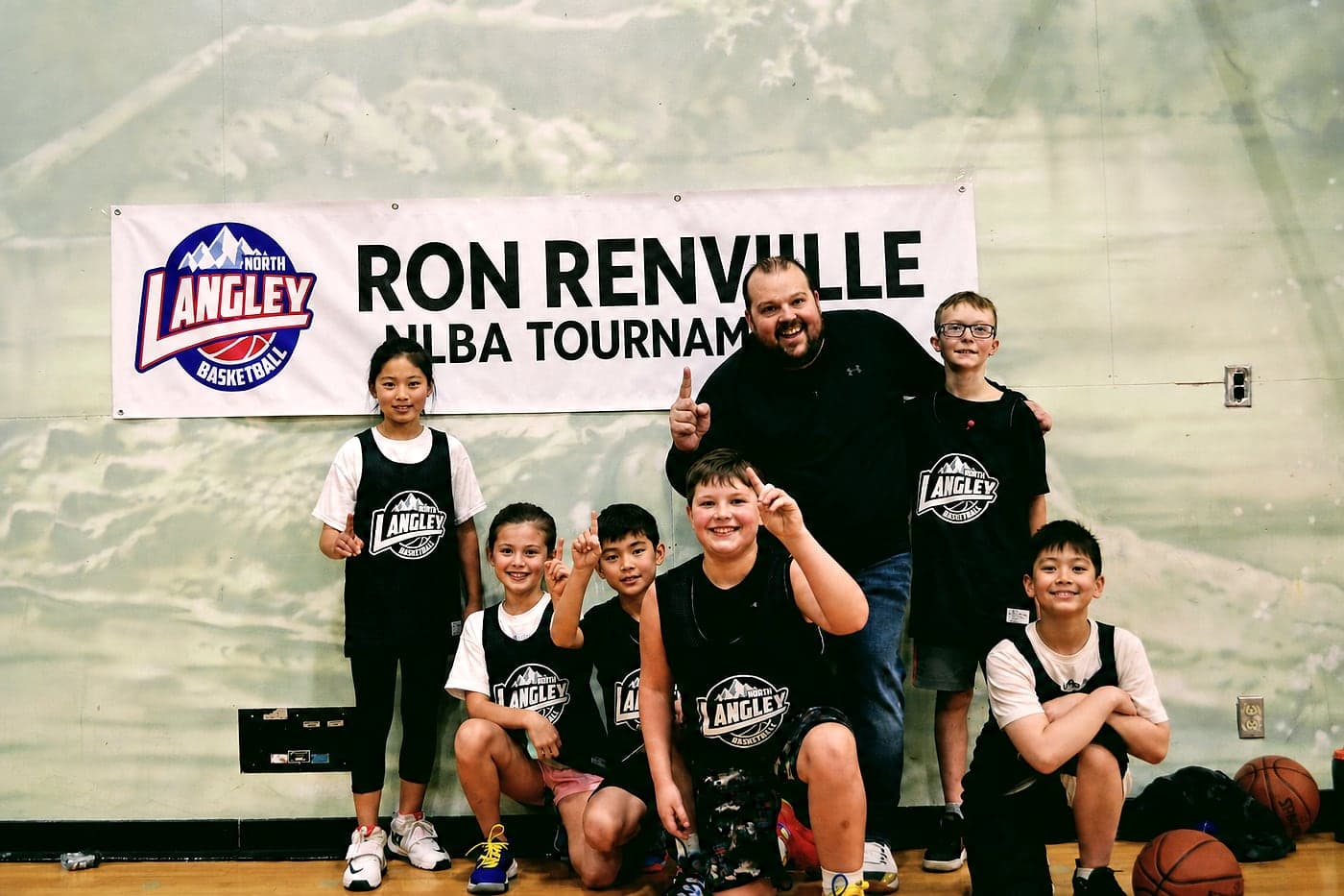 An NLBA team celebrating with their coach at the Ron Renville 3-on-3 Tournament